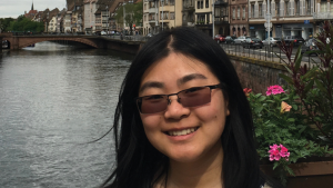 Photo of Serena Huang in front of a river and buildings in Lyon, France