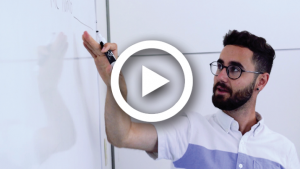 Lawrence Book McKnight pointing at a whiteboard.