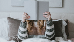 Woman reading a book in bed