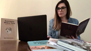 Image of Jennifer Nagtegaal on a laptop and reading books