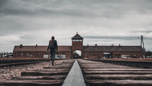 Person walking through Auschwitz concentration camp in Poland.
